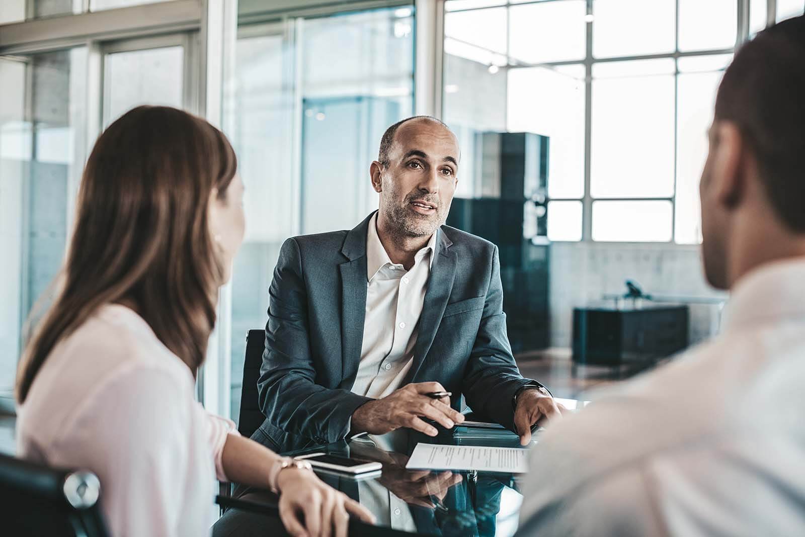 Financial Advisor meets with younger couple to discuss their personal finances and wealth management - Via Wealth