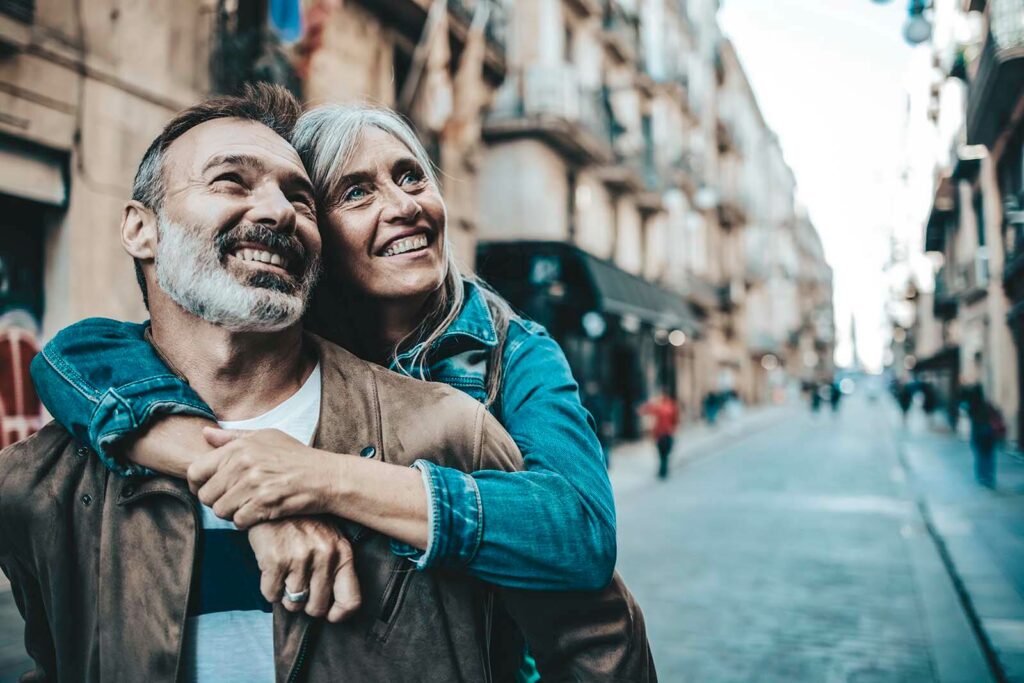 A middle-aged couple enjoying a holiday moment together - Via Wealth