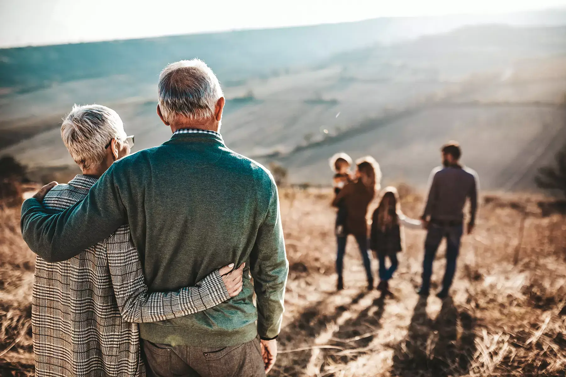 Mature couple consider their family while out walking - Via Wealth
